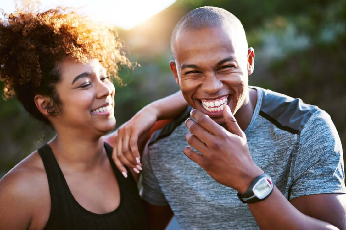 Couple in their 40s exercising together and laughing