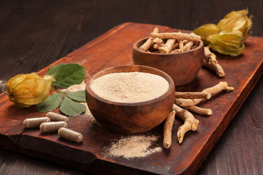 image of organic ashwagandha powder and roots displayed in wooden bowls placed on a rustic wooden chopping board