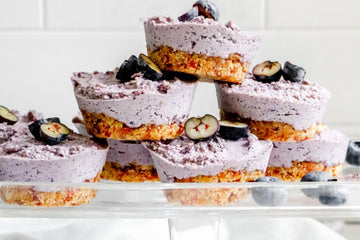image of mini vegan blueberry cheesecakes stacked on top of each other ready to eat