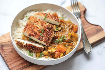 fragrant and tasty vegan tofu katsu curry with rice and vegetables served in a white ceramic bowl