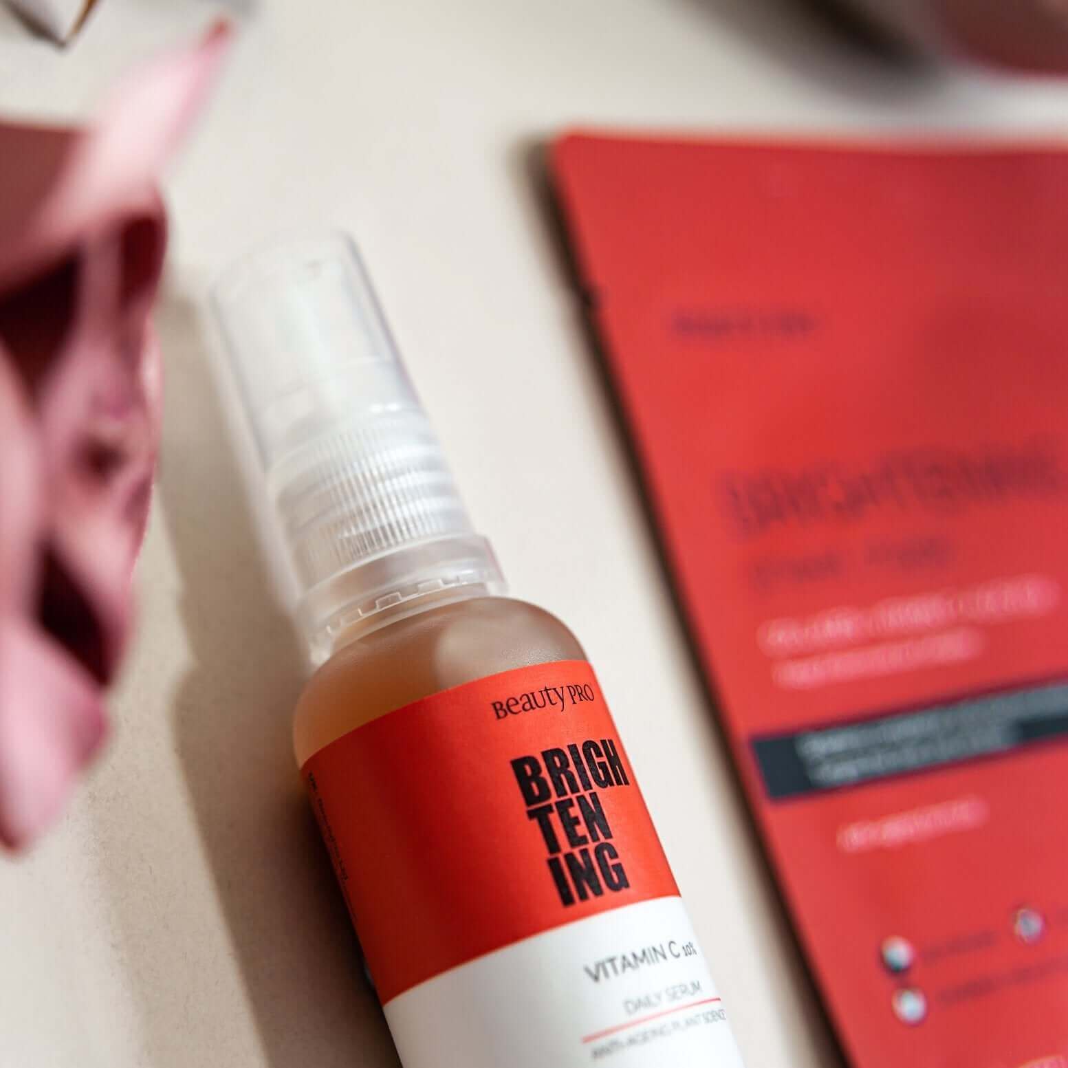  flat lay product shot of front of a single pack beauty pro brightening collagen face sheet mask and a bottle of beauty pro brightening skin serum